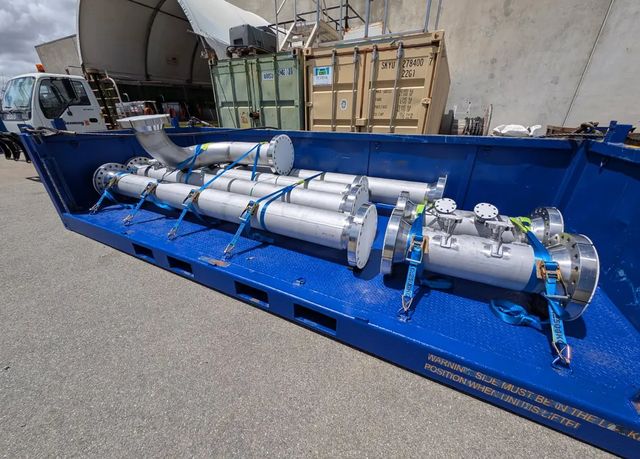 Fabricated pipe spools strapped down in a transport frame beside a Benang truck, ready for delivery